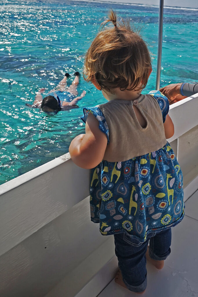 toddler looking at mom swimming 