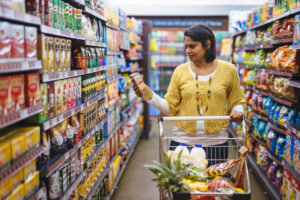 Nadia Gabriel in a shopping mall looking at a product. Her meal planning business is helping moms plan and budget.