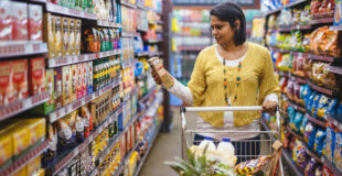 Nadia Gabriel in a shopping mall looking at a product. Her meal planning business is helping moms plan and budget.