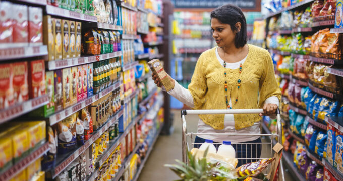 Nadia Gabriel in a shopping mall looking at a product. Her meal planning business is helping moms plan and budget.