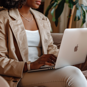 black woman typing on apple computer