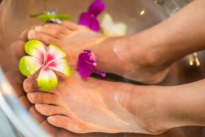 feet in water with flowers