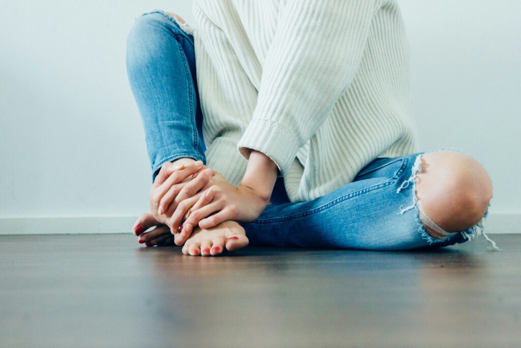 A woman holding her feet