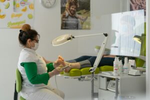 Podiatrist working on someone's foot with a ring light