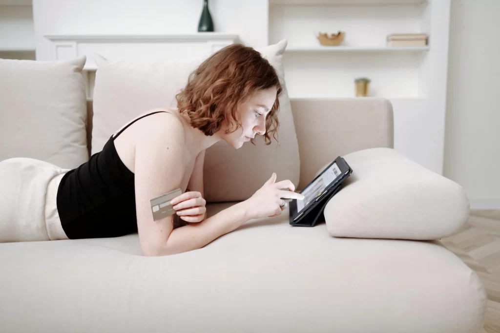 Woman on a couch doing online shopping 