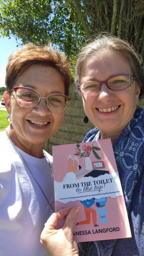 Vanessa Langford giving a persona delivery of her book to me: "From the toilet to the top." 