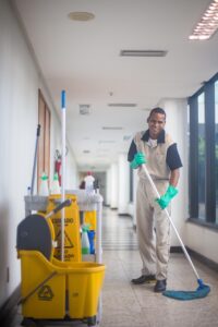 A cleaner mopping the floor