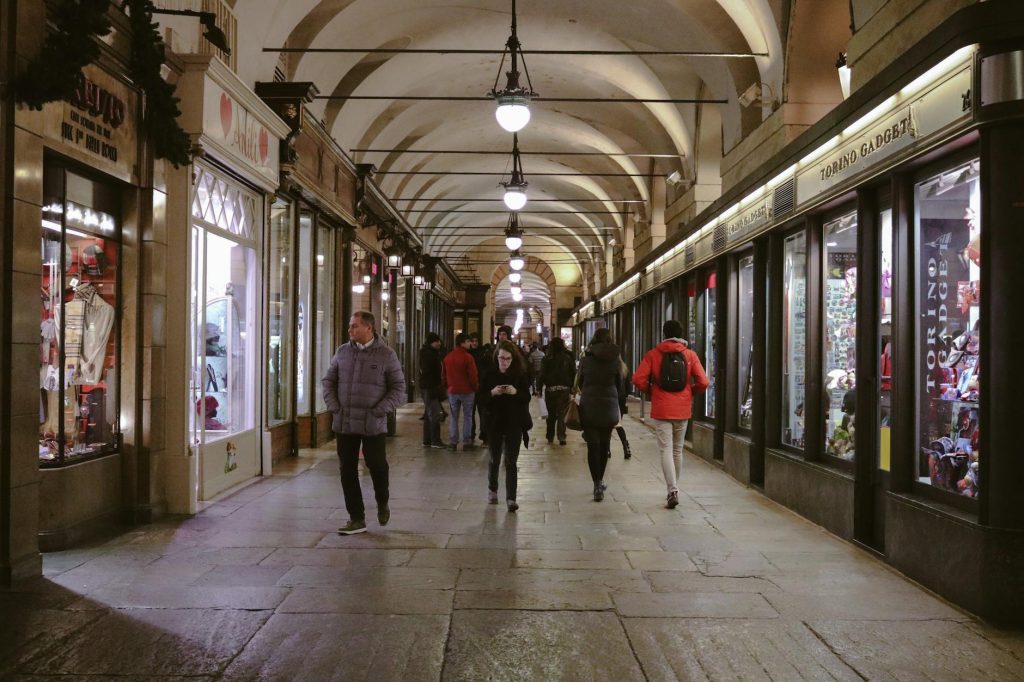 Indoor shopping arcade with footwear and fashion stores.