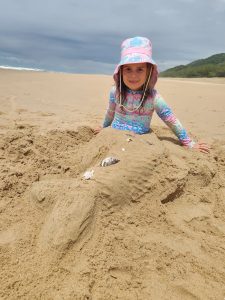 girl in  the sand with a mermaid tail