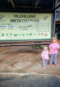 Hluhluwe–Imfolozi Park  - children standing in front of the sign
