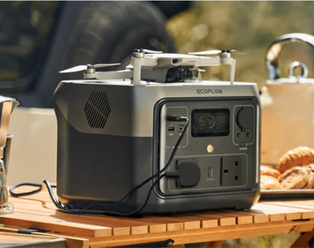 EcoFlow RIVER 2 Max Portable Power Station on a camping station powering a lamp and a drone