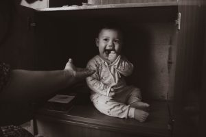 Baby eating something it shouldn't. Keep adult products safely away from children.