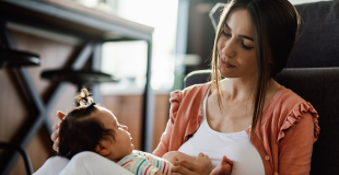 A mom with a crying baby. Babies have their own way of communicationg.