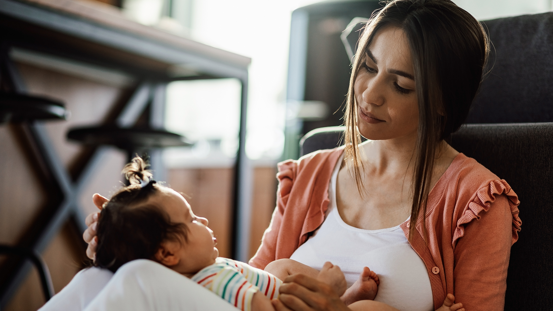 A mom with a sleeping baby. Babies have their own way of communicating their pain.