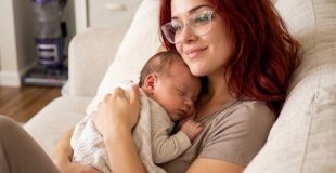 A mom with a newborn on the sofa
