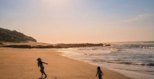 children running on the sand in the sun at the Wild Coast Sun