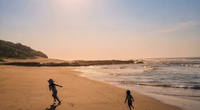 children running on the sand in the sun at the Wild Coast Sun