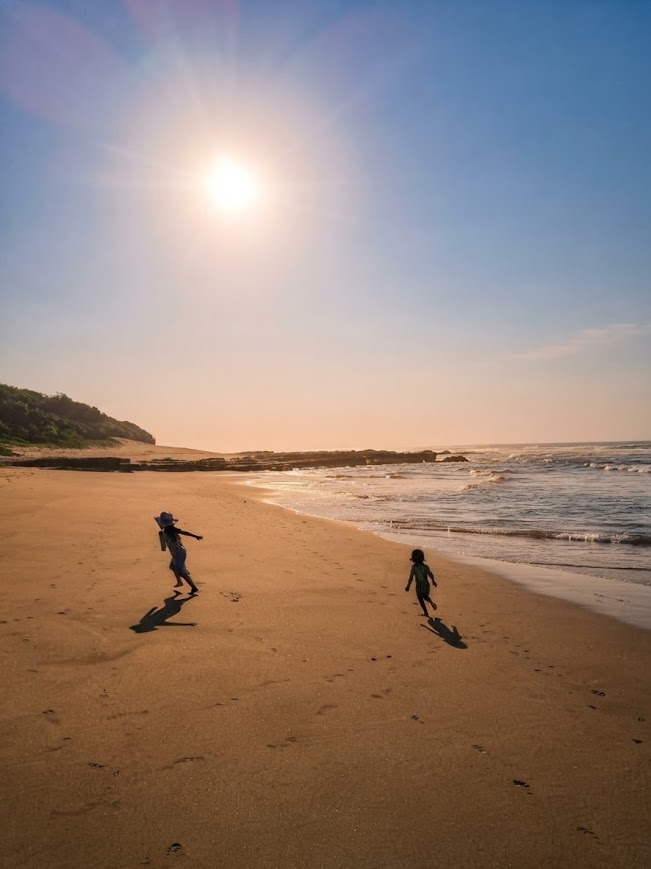 children running on the sand in the sun at the Wild Coast Sun