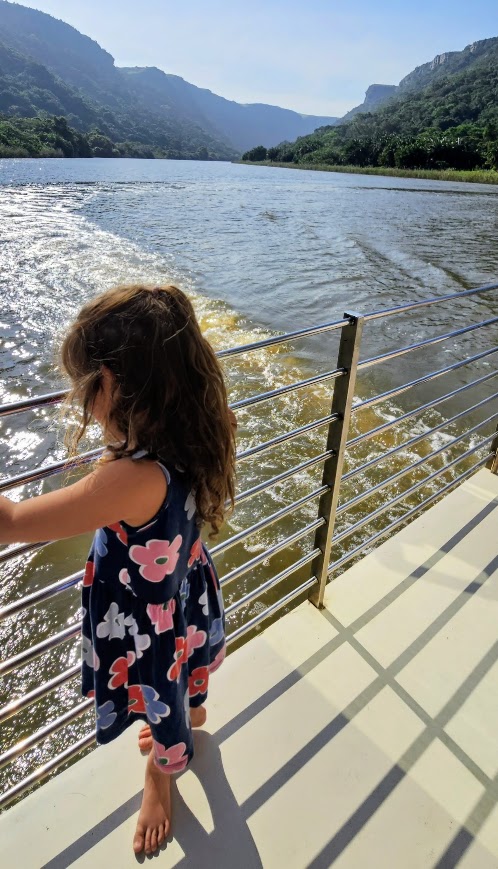 child on boat looking at the water on the river boat cruise