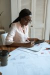 Woman with a a calculator working out a loan repayment. 